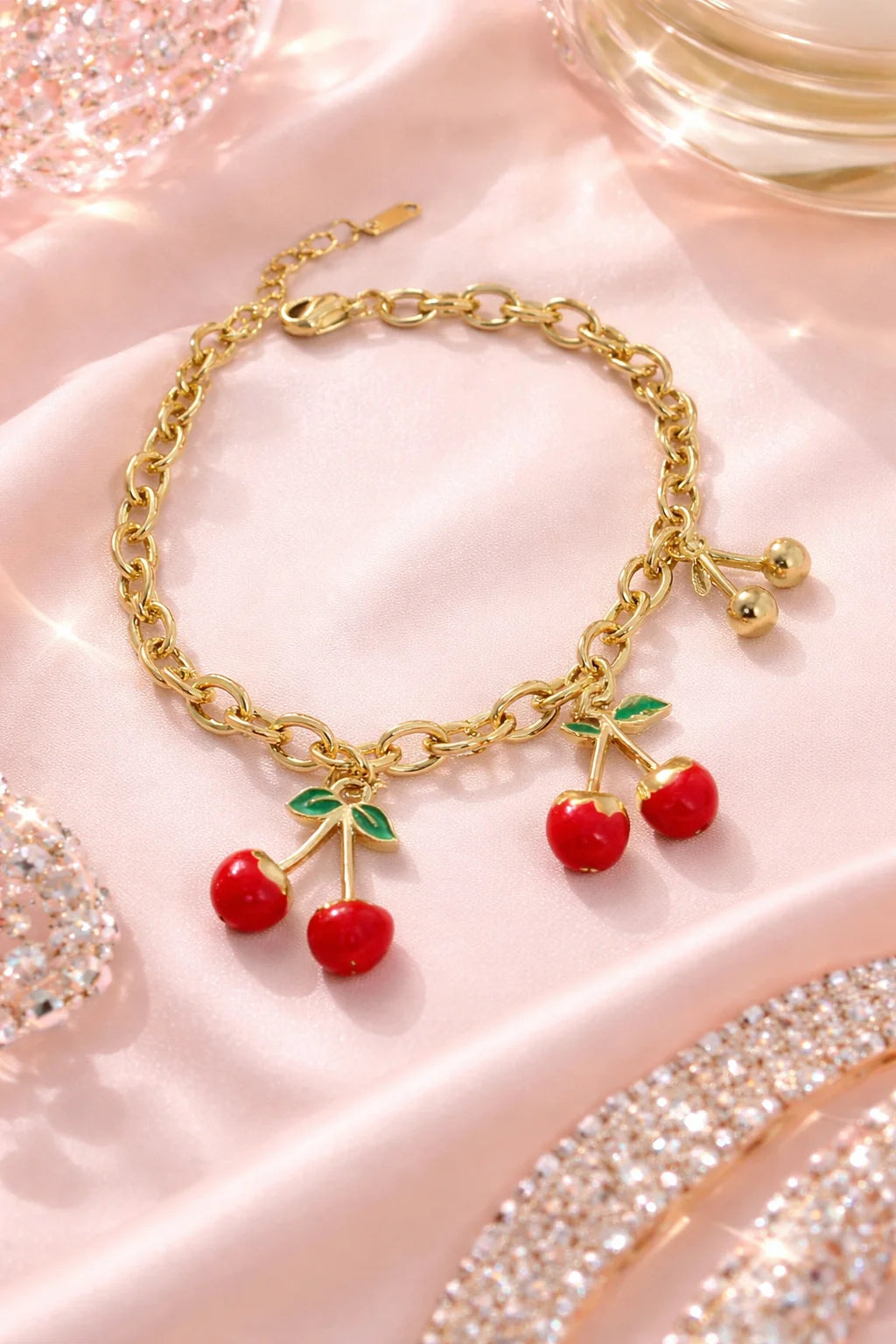 Gold cherry bracelet with red bead cherries and green leaf drop charms