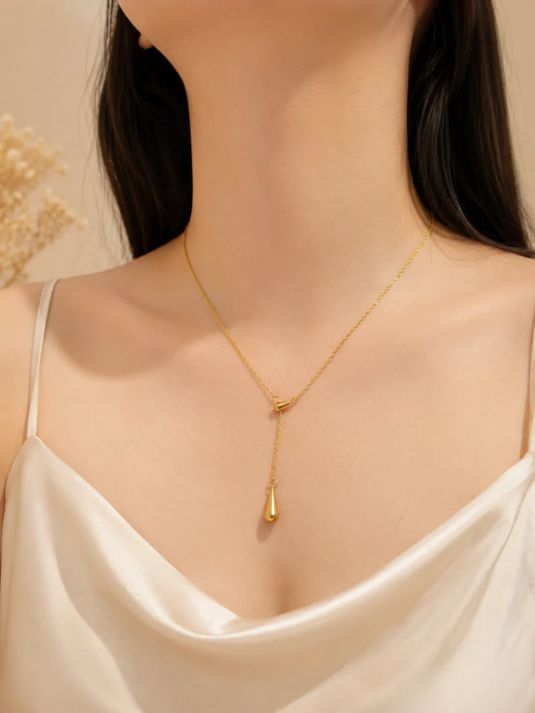 Gold drip pendant necklace with long teardrop drop charm on thin chain