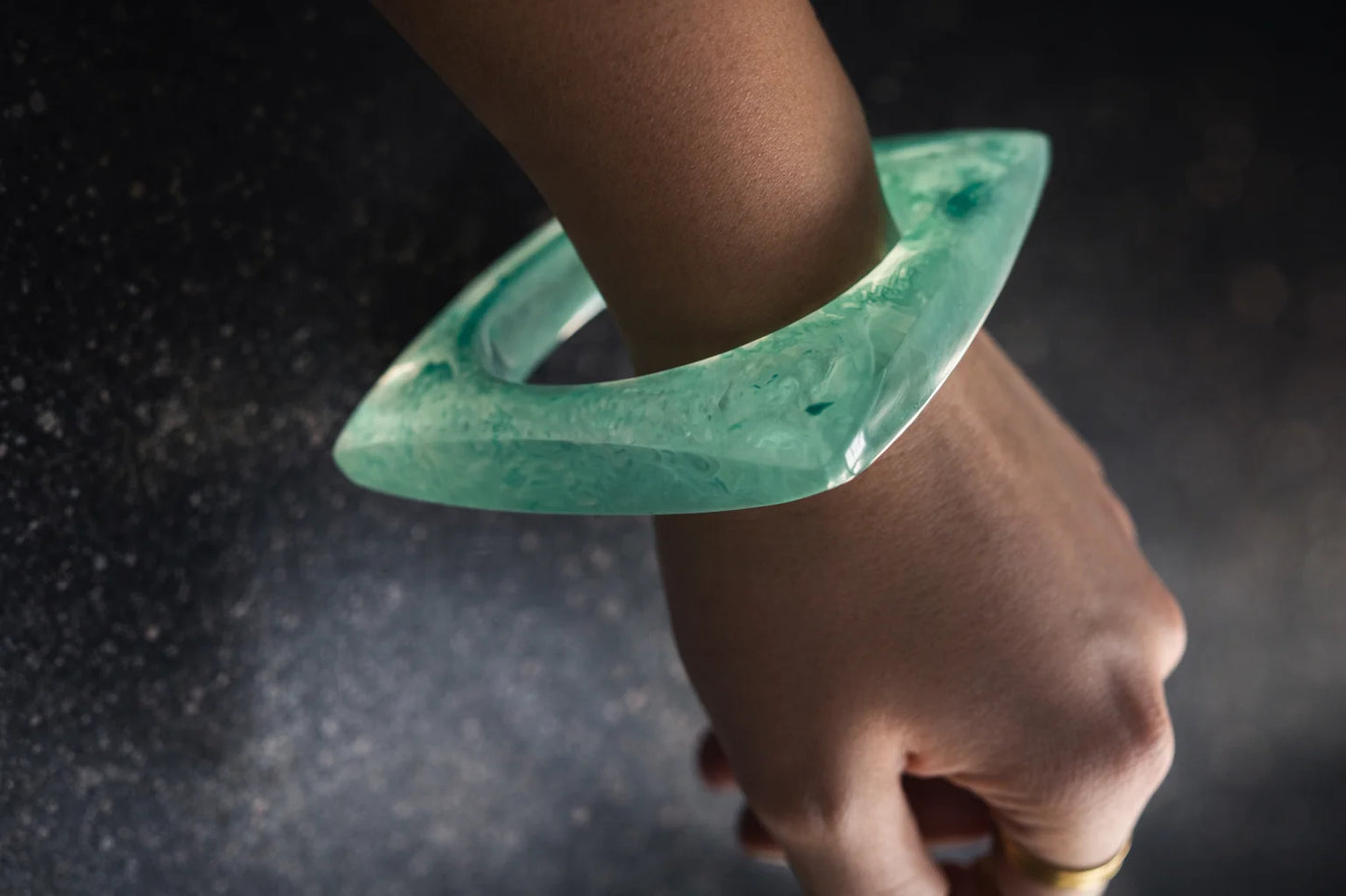 Teal resin kada bracelet with curved open shape, translucent marbled texture