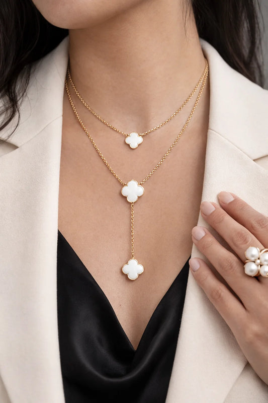 Double-layer clover drop necklace with gold chain and three white clover charms on model