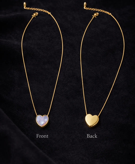 Two heart pendant necklaces on gold-tone chains: blue front, cream back