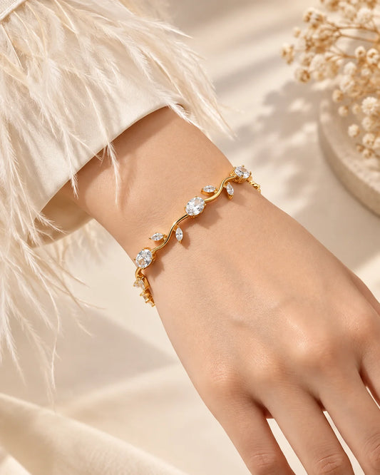 Gold-tone tulip bracelet with linked clear stones on wrist