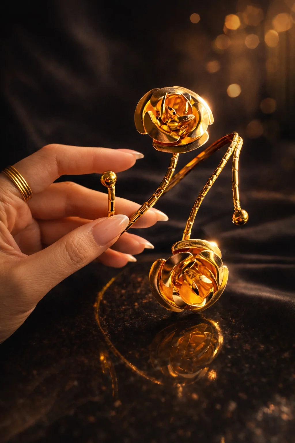 Gold rose statement arm cuff with dangling chain drops and floral rosette detail