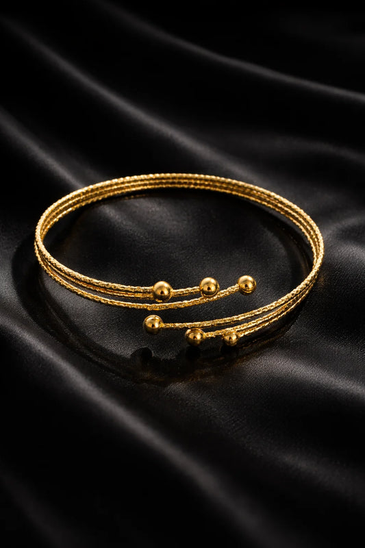 Gold arm cuff bracelet with triple wrap and small ball beads, adjustable fit