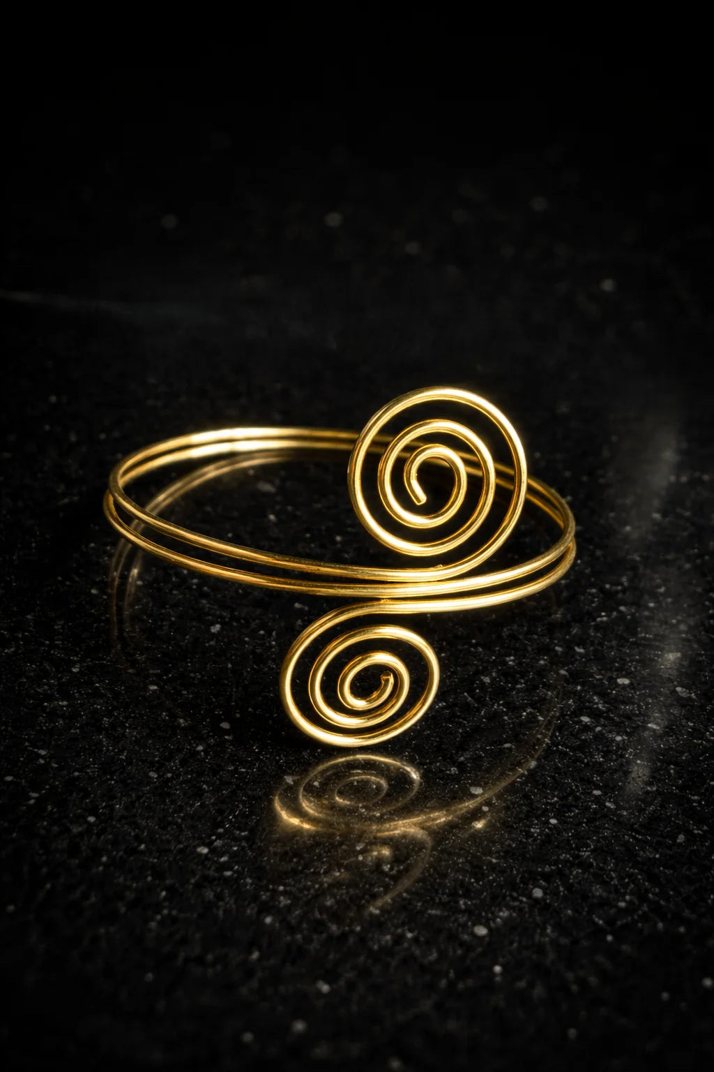 Gold spiral arm cuff with two rounded scroll details