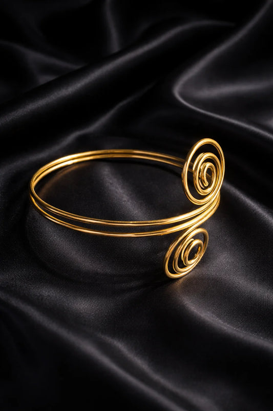 Gold wire arm cuff with spiral scroll ends