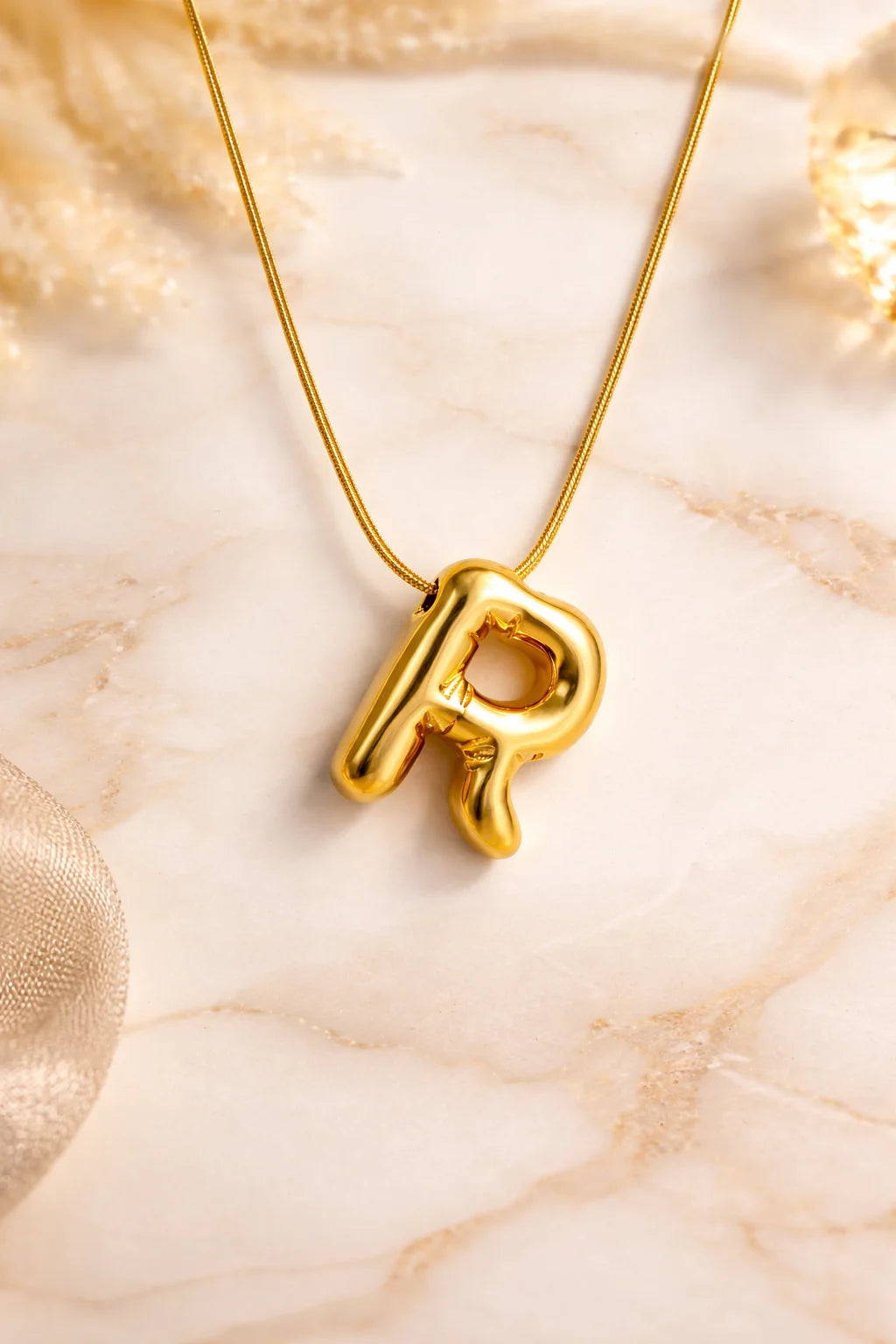 Letter R pendant necklace with gold-tone chain and glossy R charm