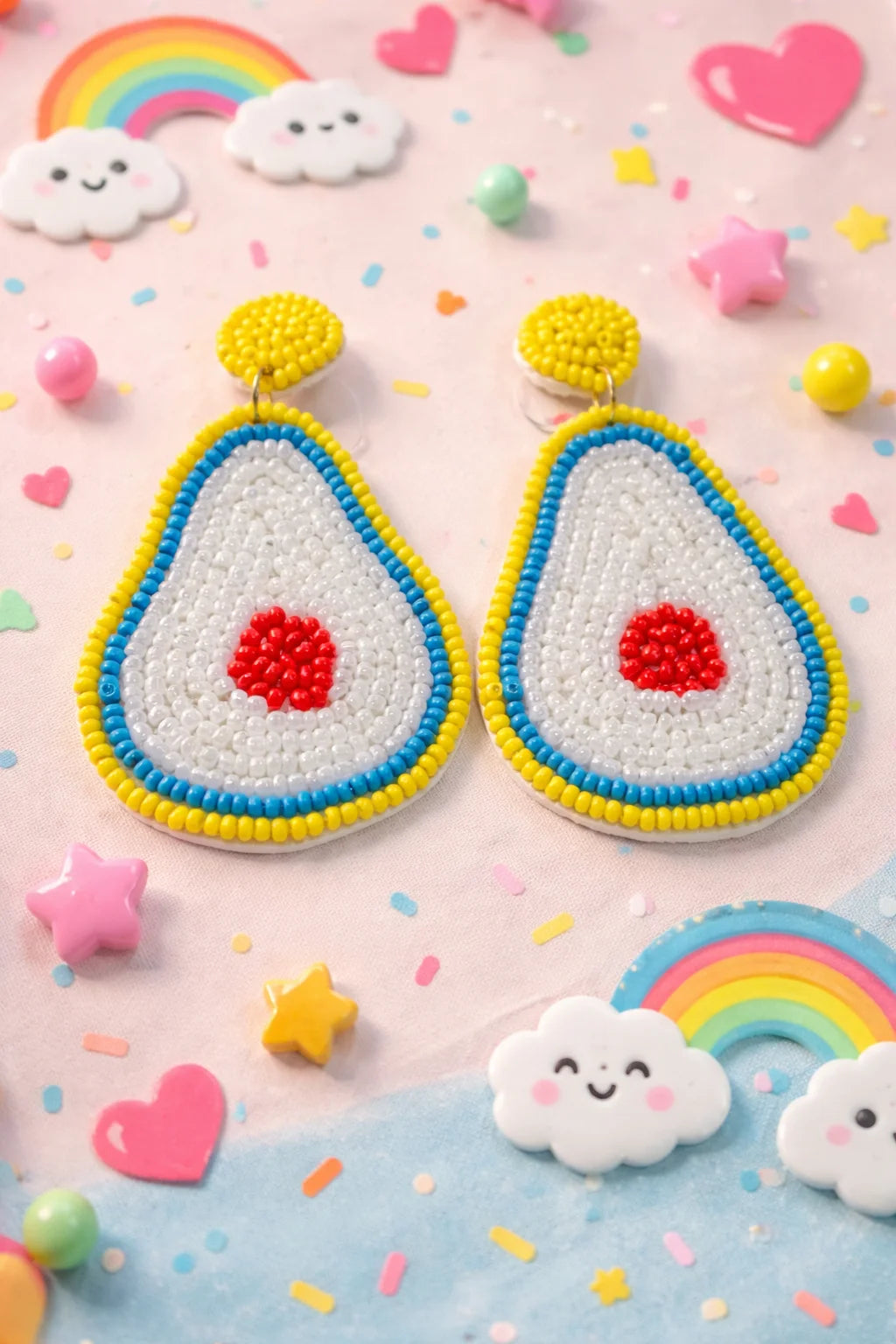 Beaded avocado drop earrings with blue and yellow trim, red center, dangling