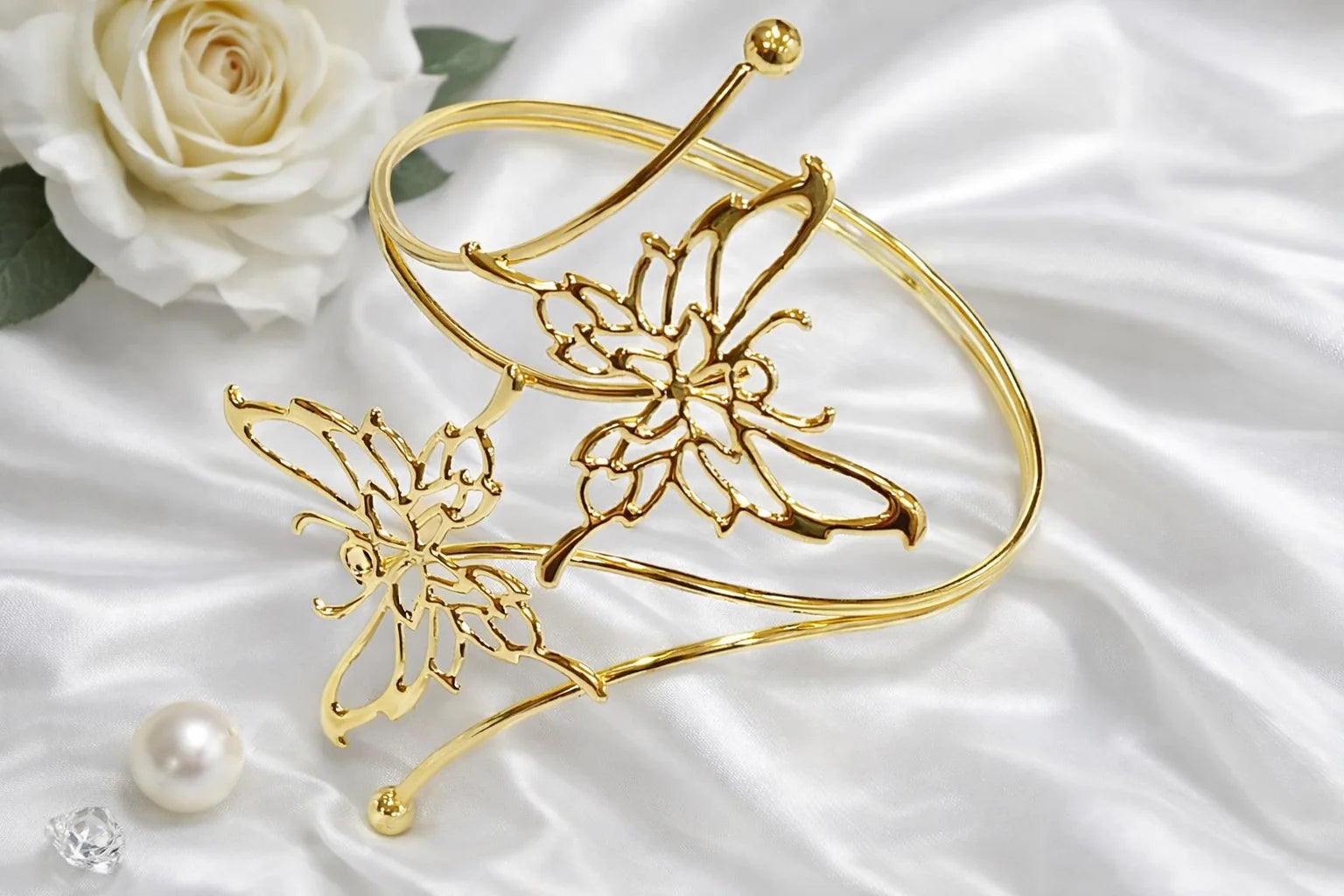 Gold flutter arm cuff with floral and butterfly filigree, open bangle with ball tips