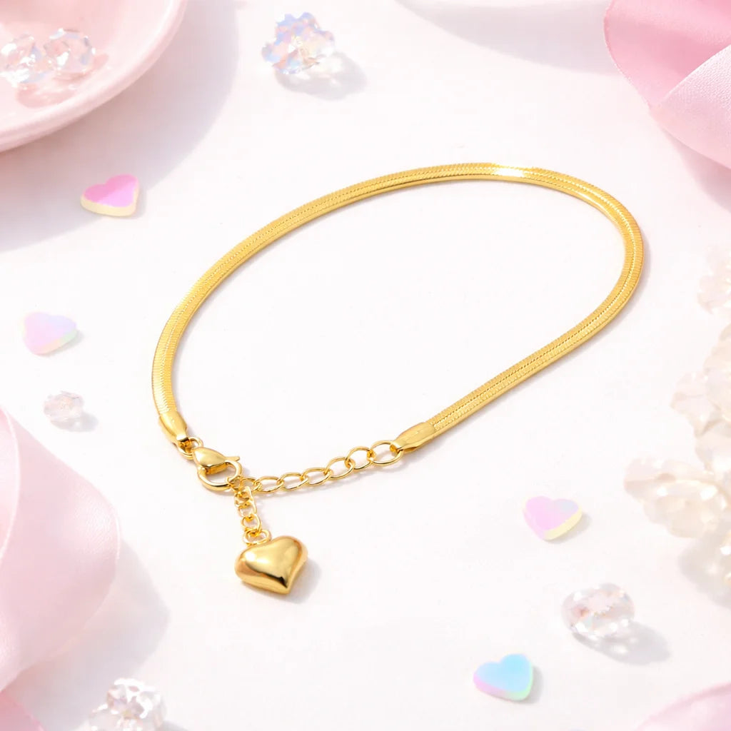 Gold-tone snake-style bracelet with heart charm and small link chain adjuster