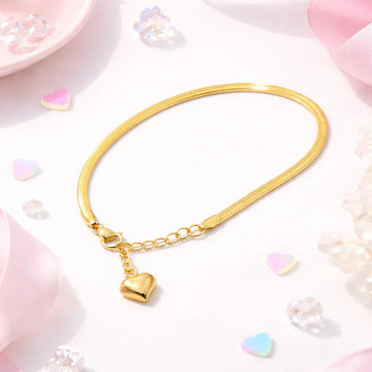 Gold-tone snake-style bracelet with heart charm and small link chain adjuster