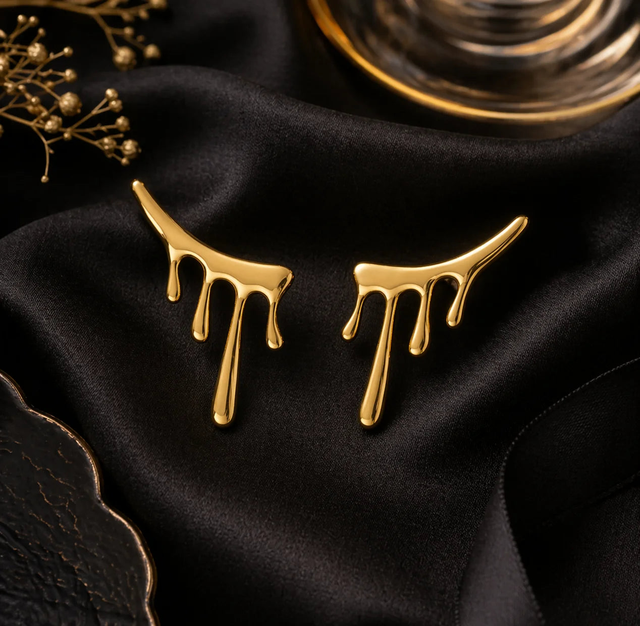 Gold drop-style statement earrings with three dangling drips