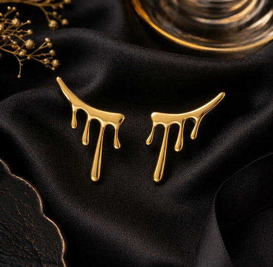 Gold drop-style statement earrings with three dangling drips