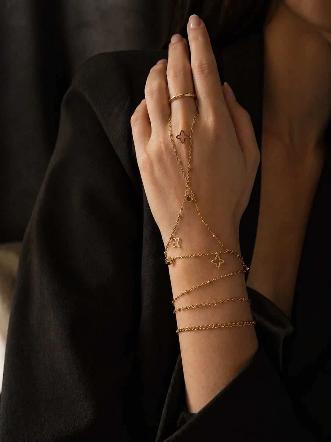 Gold-plated bracelet stack with star charms and layered chain links