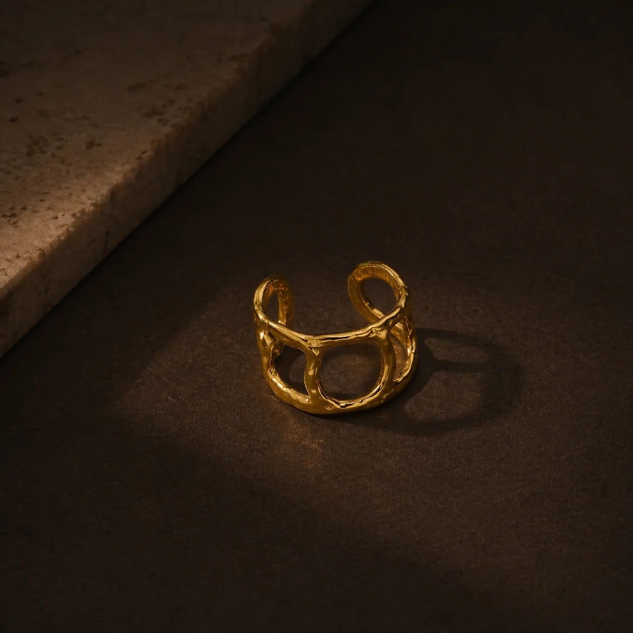 Gold open ring with square center frame and curved top bar