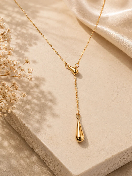 Gold teardrop pendant necklace, layered loop and long drop detail