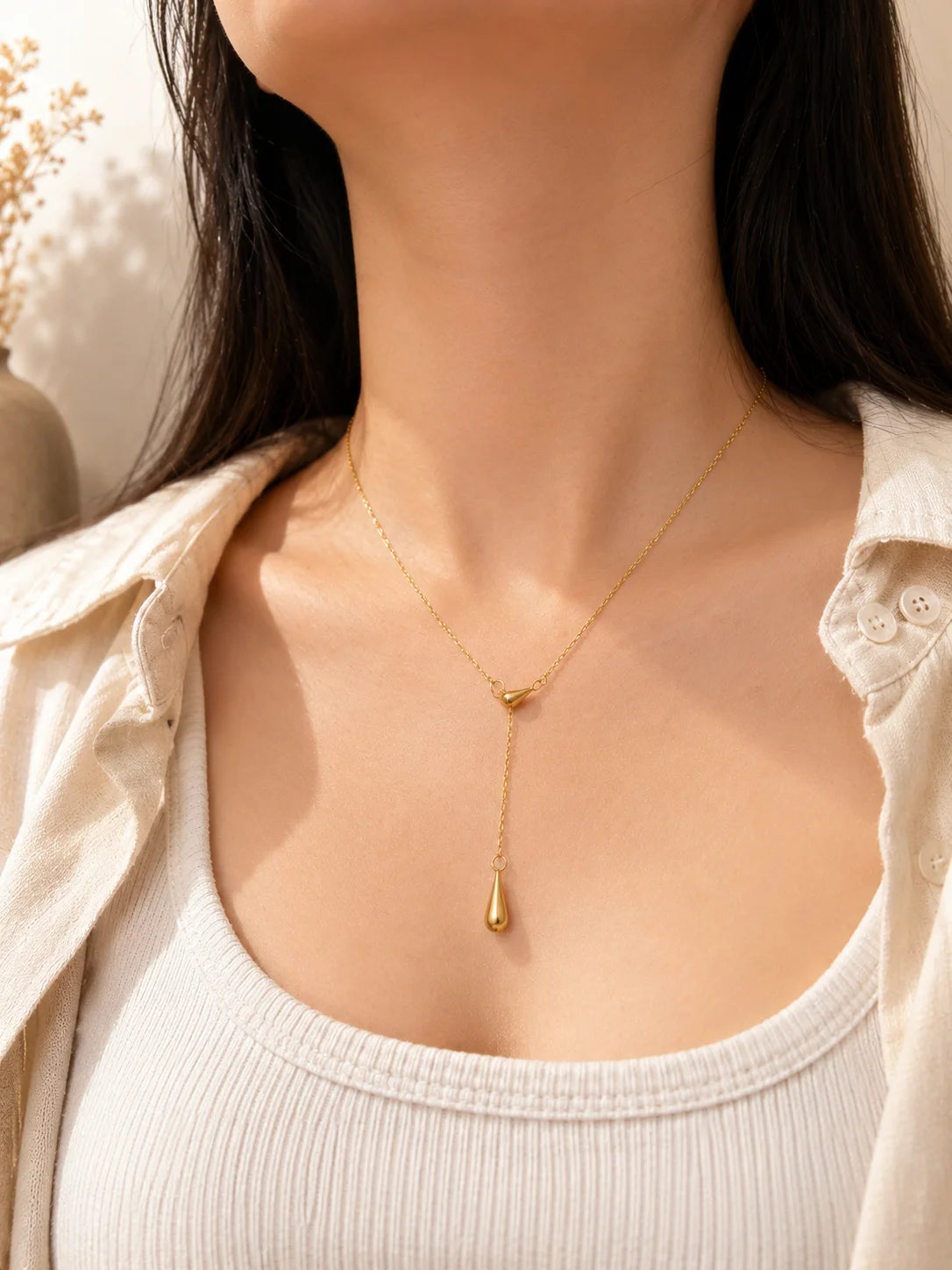 Gold drip pendant necklace with teardrop charm on fine chain