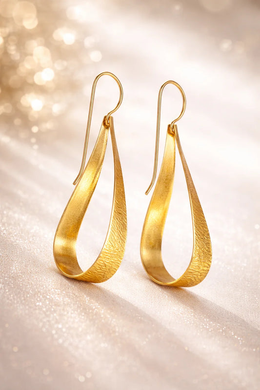 Shimmering gold-tone sculpted teardrop loop earrings with hooked ear wires.