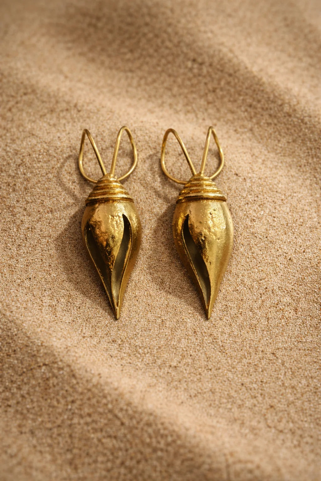 Pair of gold teardrop ear cuffs with small loop and pointed tip