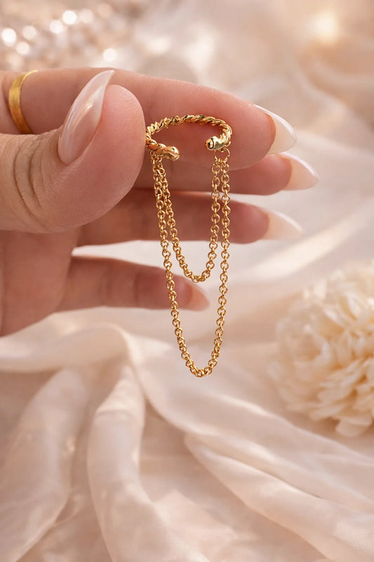 Gold drop ear cuff with two dangling chain strands, curved cuff design