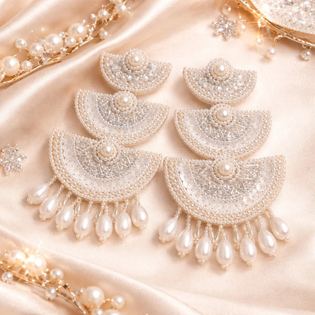 White beaded chandelier earrings with pearl center and teardrop drops