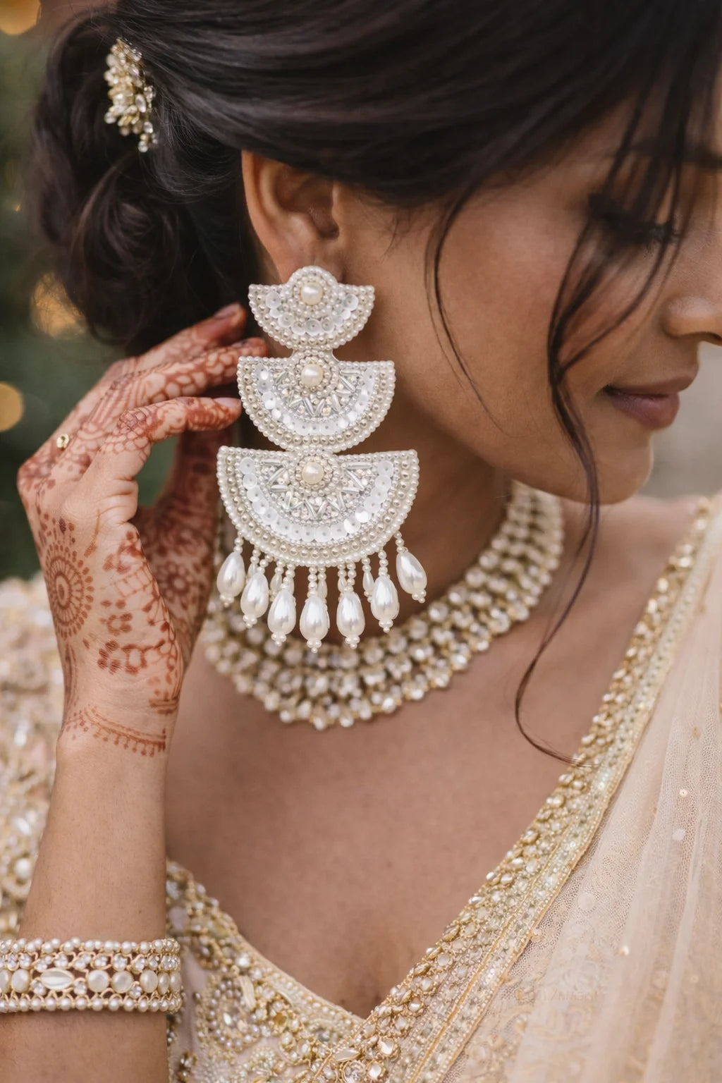 Long white beaded earrings with stacked pearl centers and drop fringe