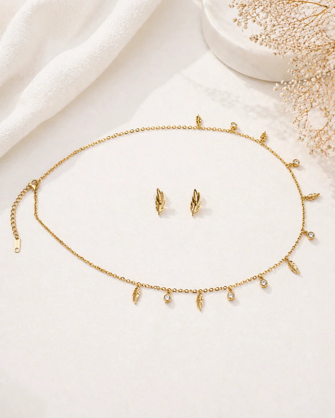 Gold-plated feather charm choker necklace with small round stone accents