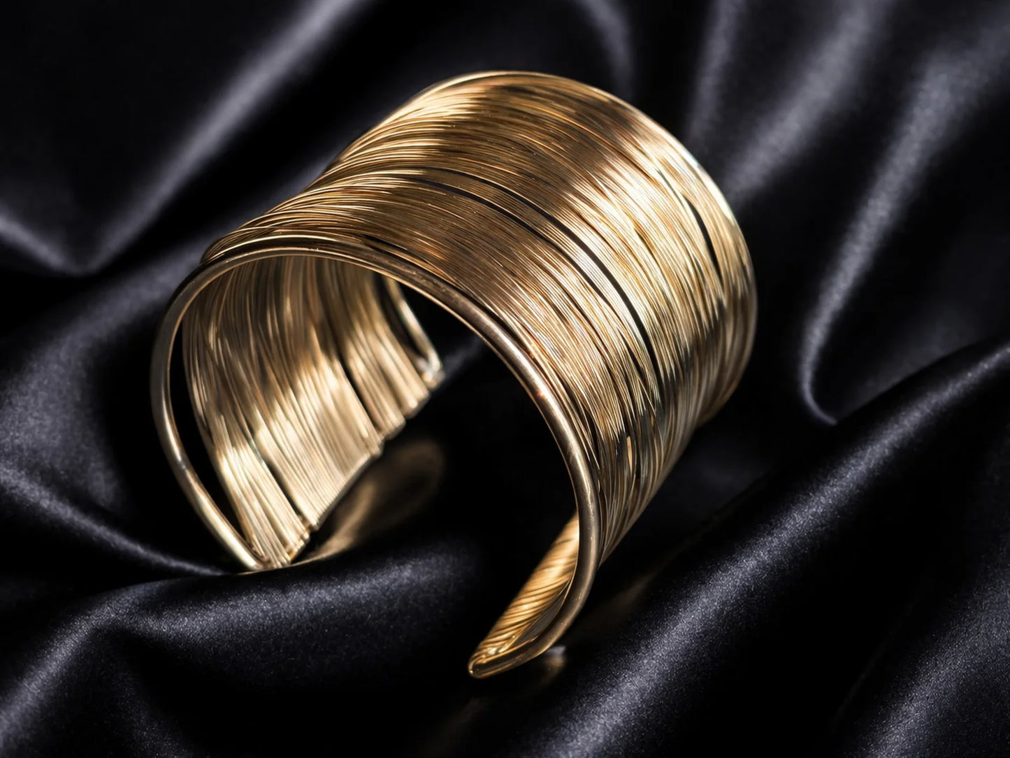 Gold-toned chunky kada with multiple wire-like bands, open cuff