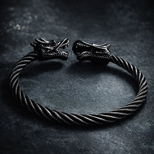 Black braided bracelet with metal dragon cuffs and twisted cord ends