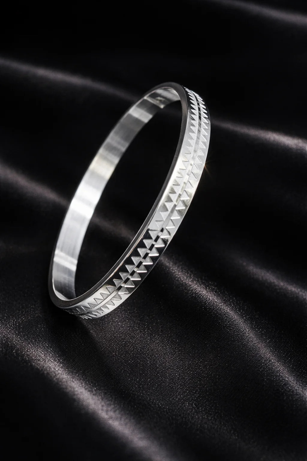 Stainless steel men's kada bracelet with raised geometric pattern and brushed finish