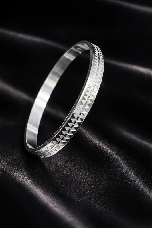 Stainless steel men's kada bracelet with raised geometric pattern and brushed finish