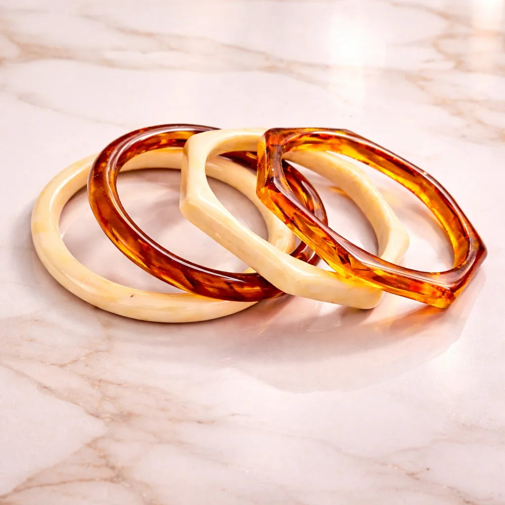 Set of four resin bangles: cream and amber tortoiseshell glossy bracelets