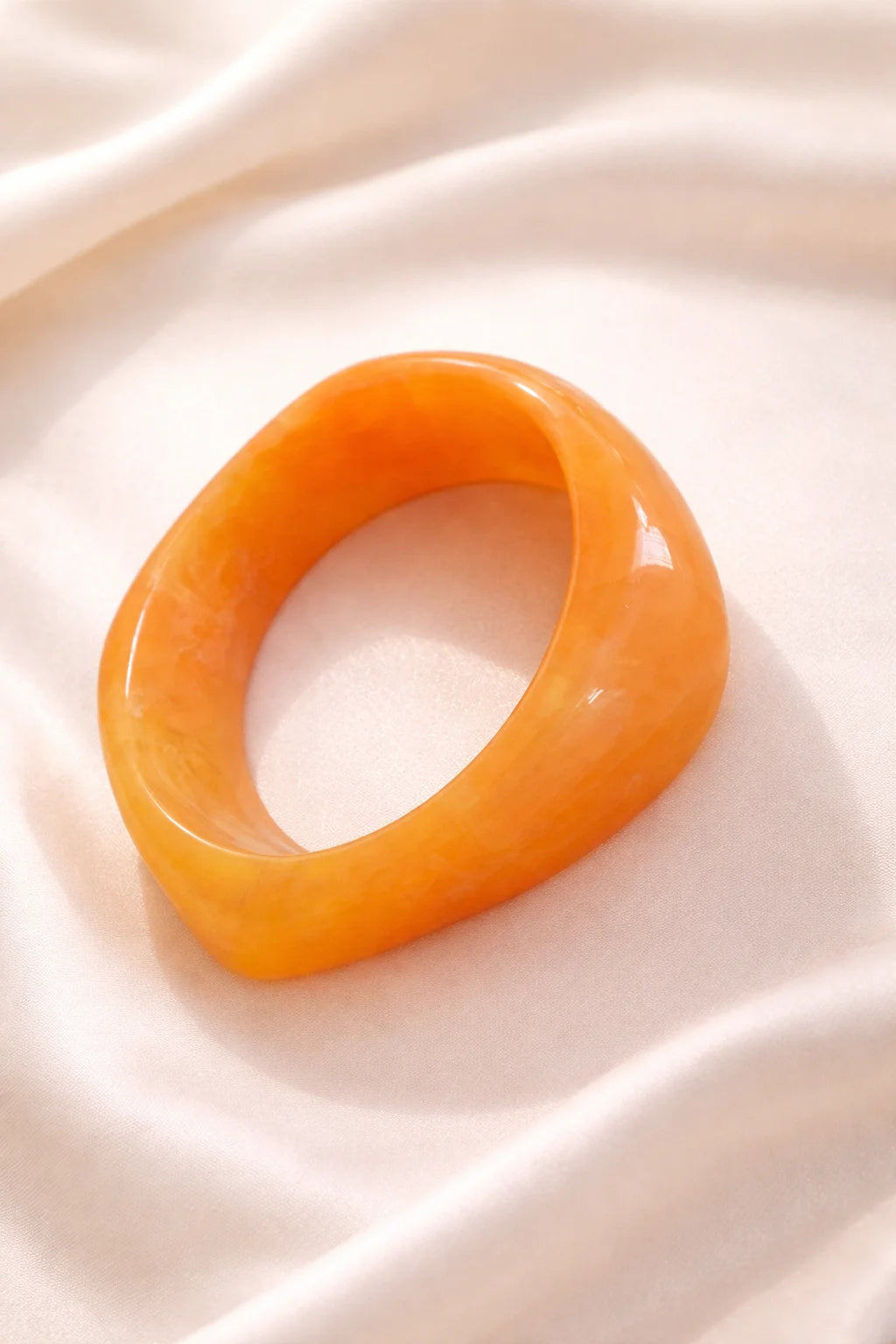 Orange resin bangle bracelet, glossy oval band