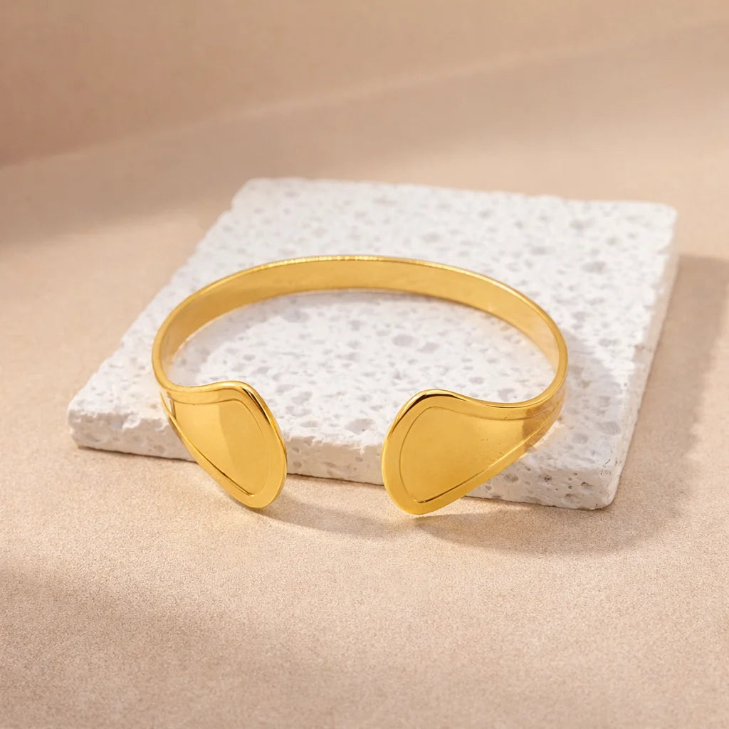 Gold kada cuff bangle with two sculpted ends, slim curved band