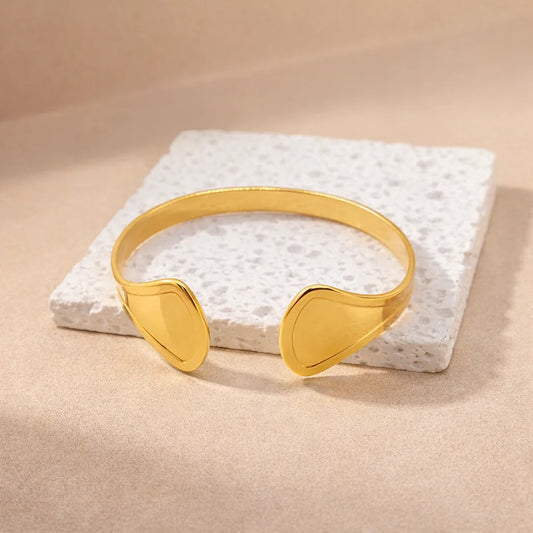 Gold kada cuff bangle with two sculpted ends, slim curved band
