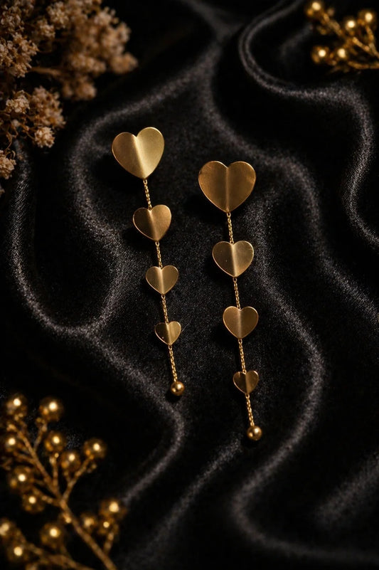 Gold-plated heart drop earrings with three hanging hearts and dangling beads