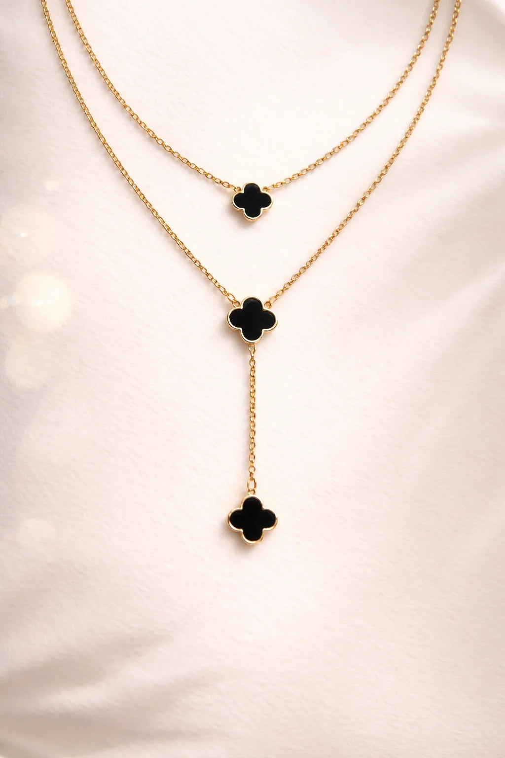 Gold-tone double-layer necklace with black clover drop charms