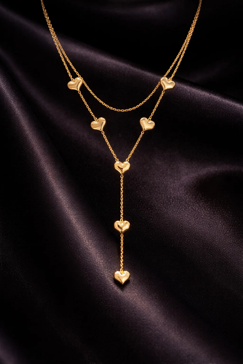 Layered heart drop necklace with gold-tone chain and small heart charms