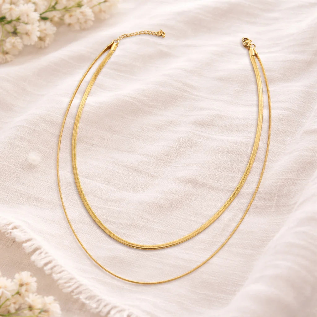 Layered snake chain necklace set with two gold-tone strands