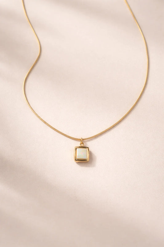 Gold-tone square pendant necklace with light stone on thin chain