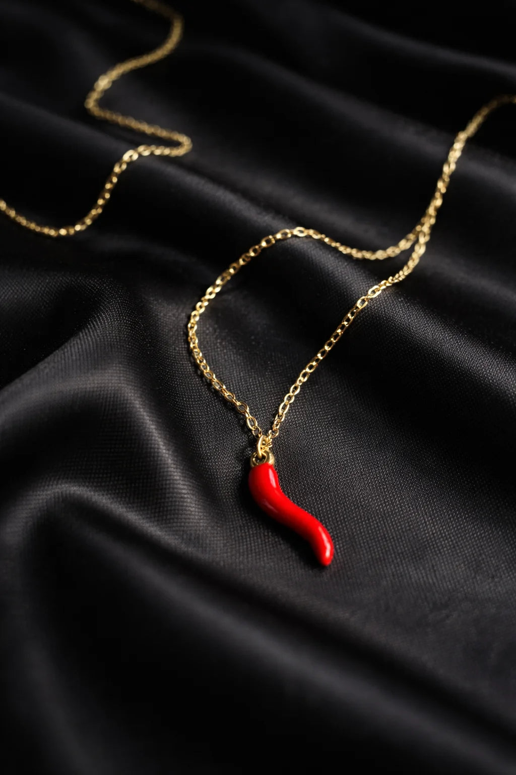 Gold-tone necklace with red chili pendant on a fine chain