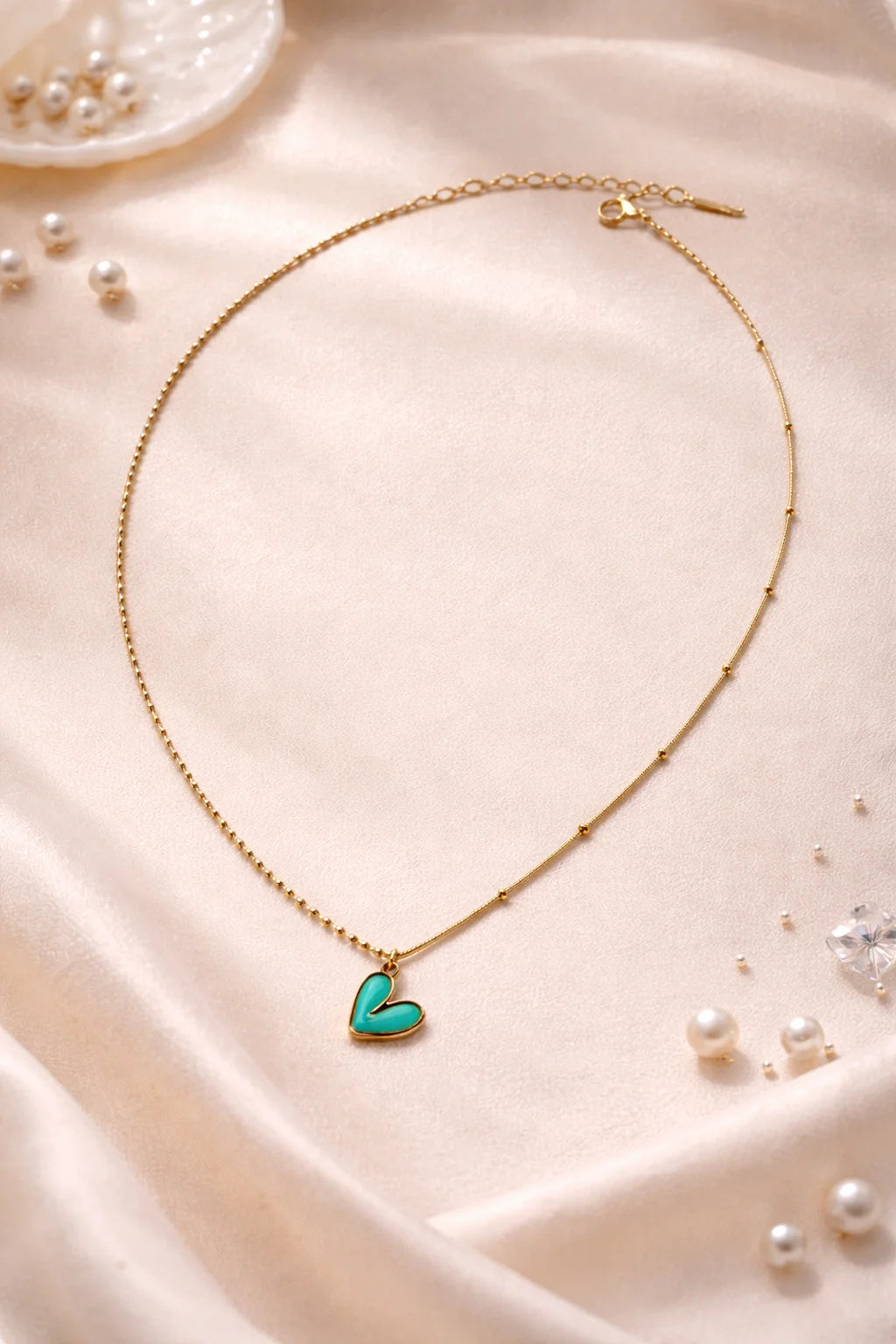Gold necklace with turquoise enamel heart pendant on fine chain