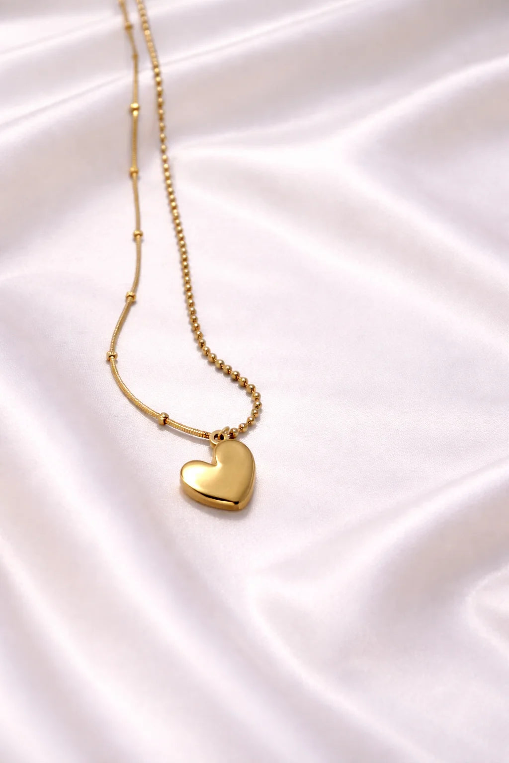 Gold necklace with plain heart pendant on thin chain