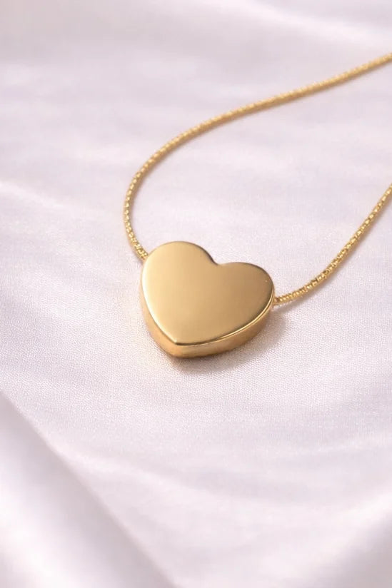 Gold-tone necklace with heart pendant and pearl-look cream stone