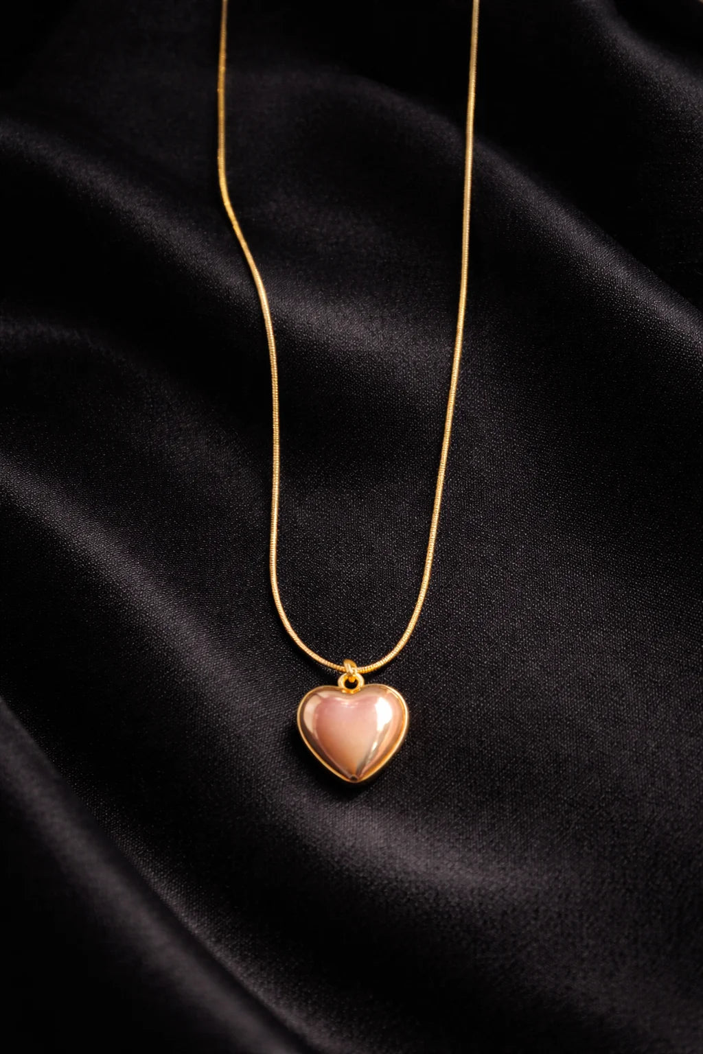 Gold-tone heart necklace with small heart pendant and rose enamel center