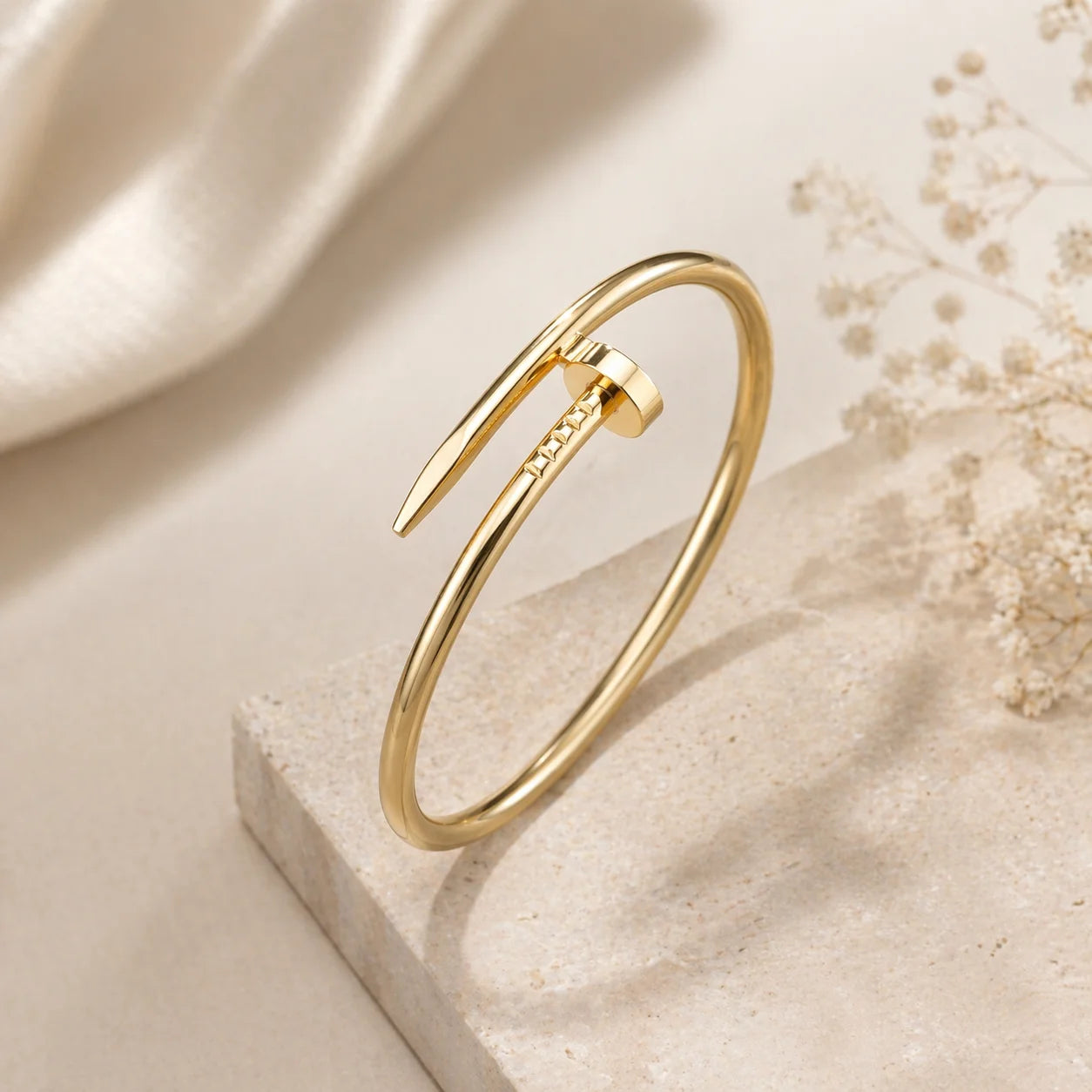 Gold-tone open cuff bangle bracelet with pointed ends and slim band