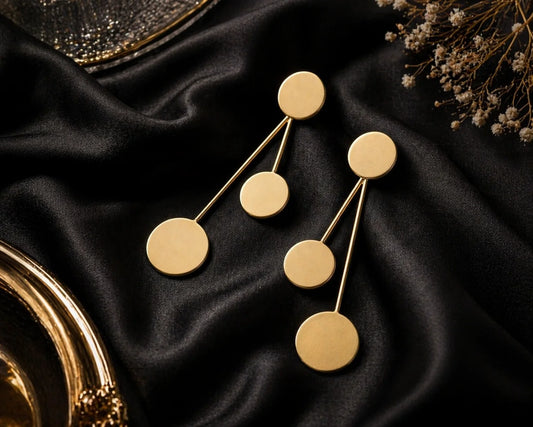 Gold-tone orbit drop earrings with three round discs connected by thin bars