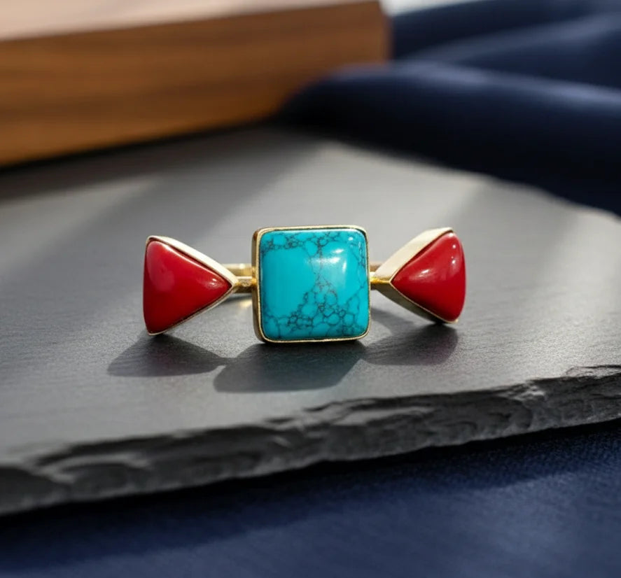 Gold-tone statement ring with turquoise square stone and two red triangular accents