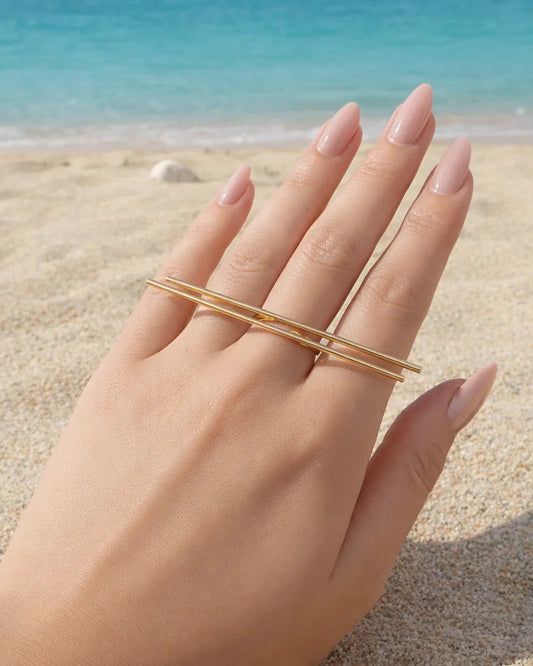 Gold-tone statement ring with oval frame and straight bar band
