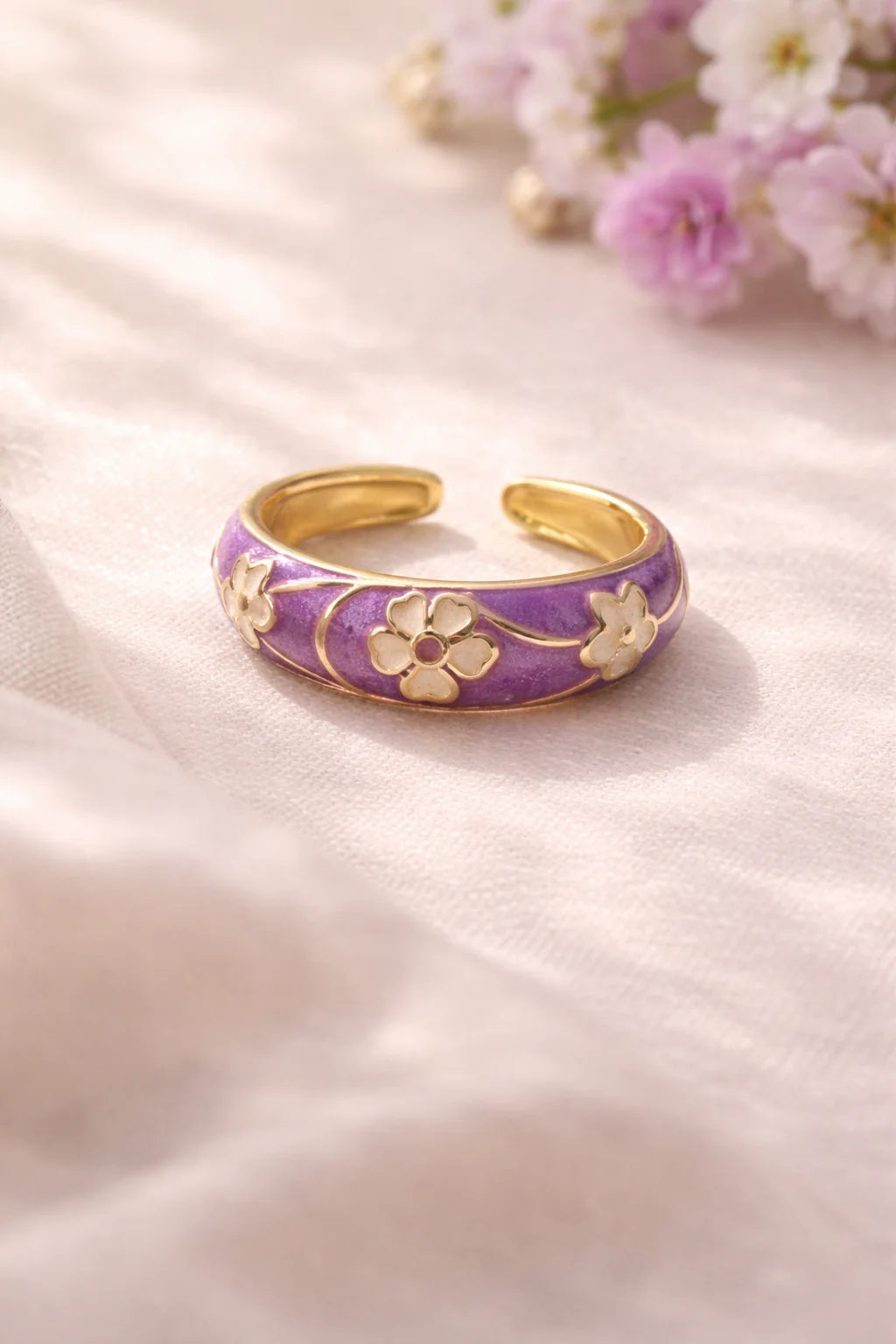 Purple enamel open cuff ring with gold-tone flower centerpiece and accents
